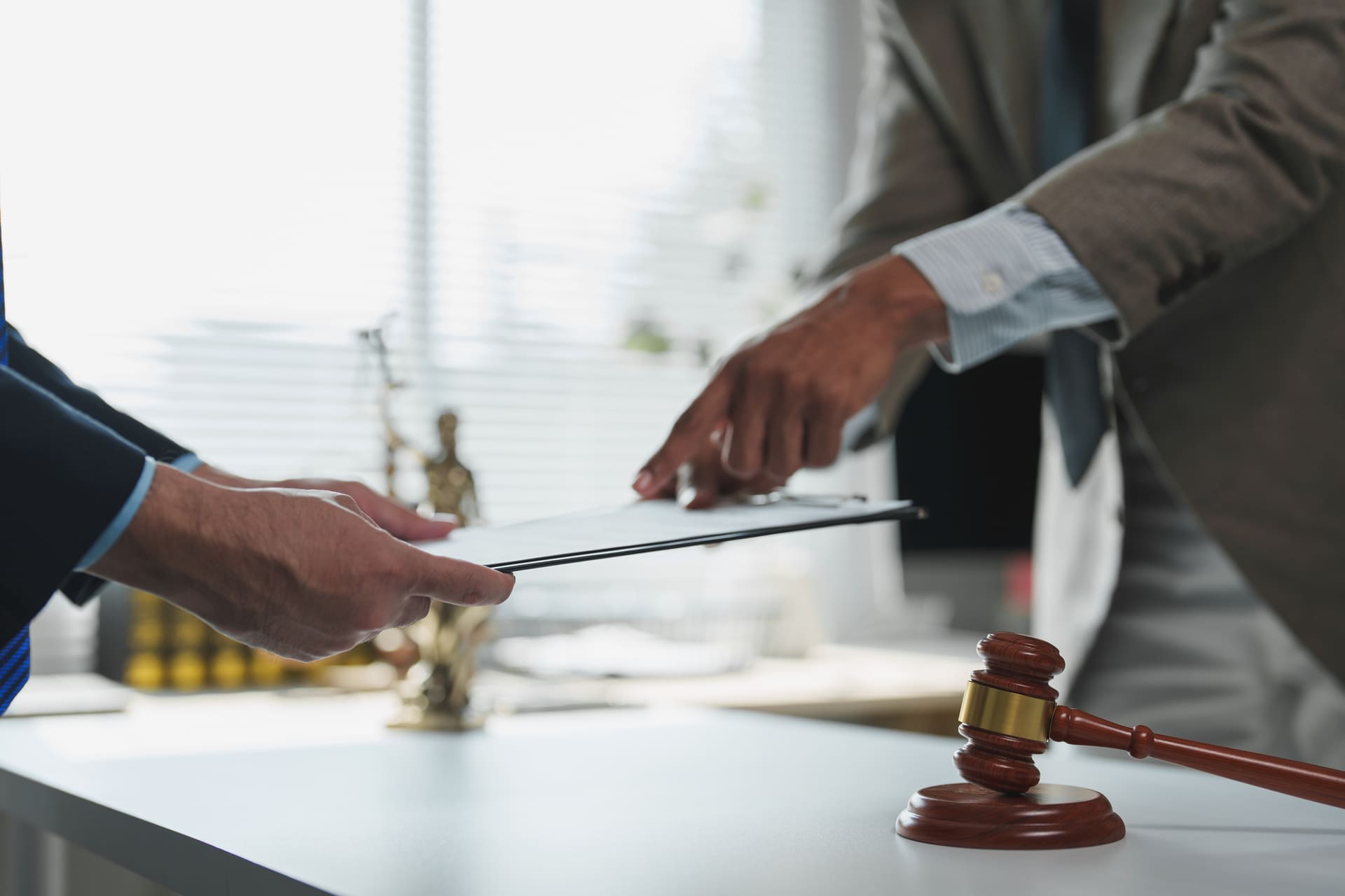 Lawyers reviewing and exchanging legal documents in an office