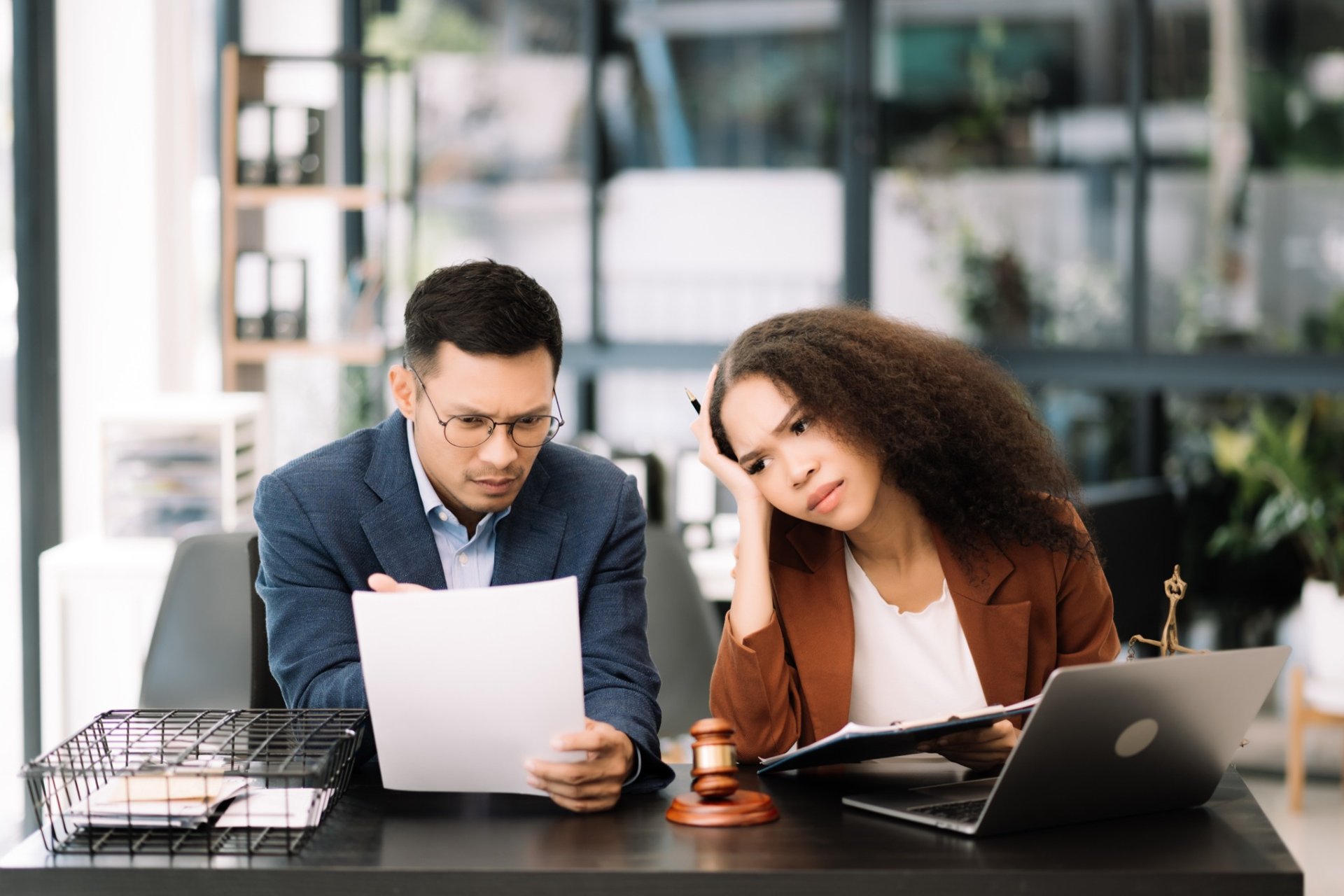 Business professionals discussing documents in a modern office