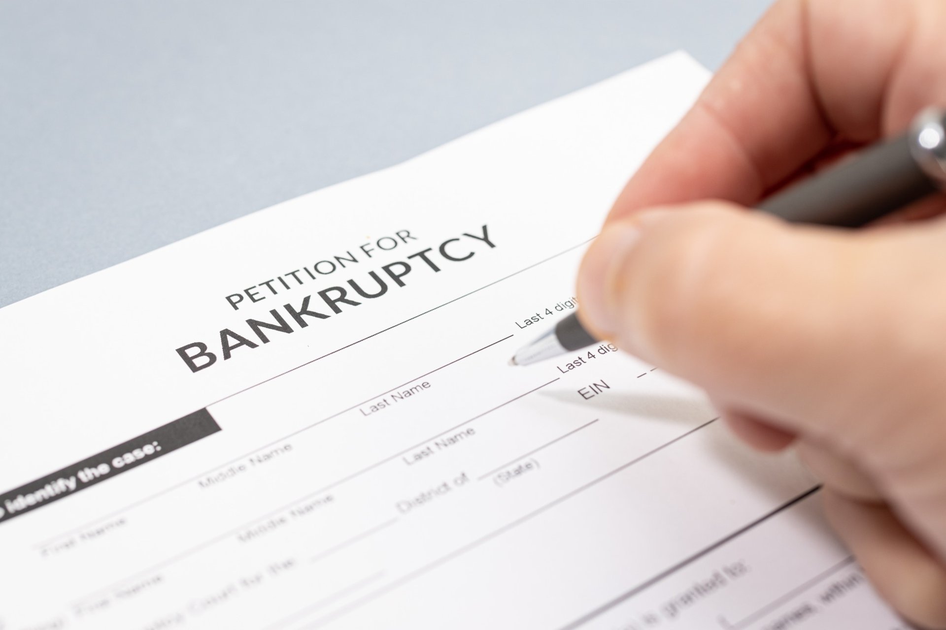 Hand signing a bankruptcy petition form