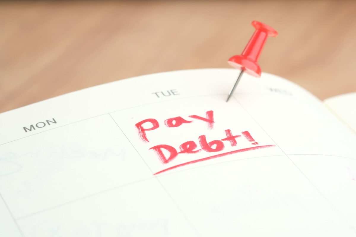 close-up-of-pay-debt-word-on-calendar