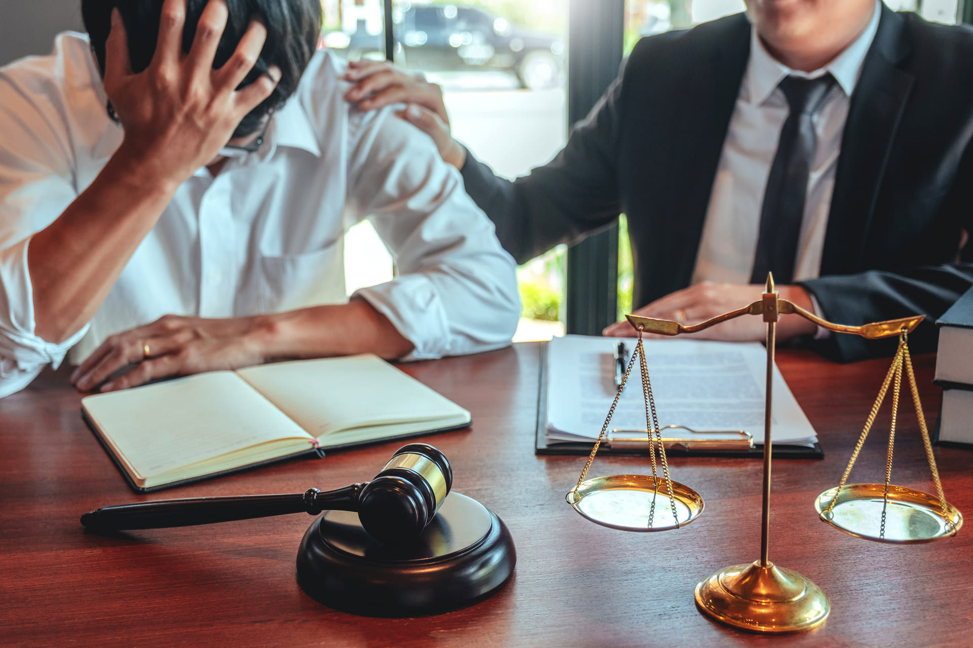 attorney putting hands on troubled client's shoulder