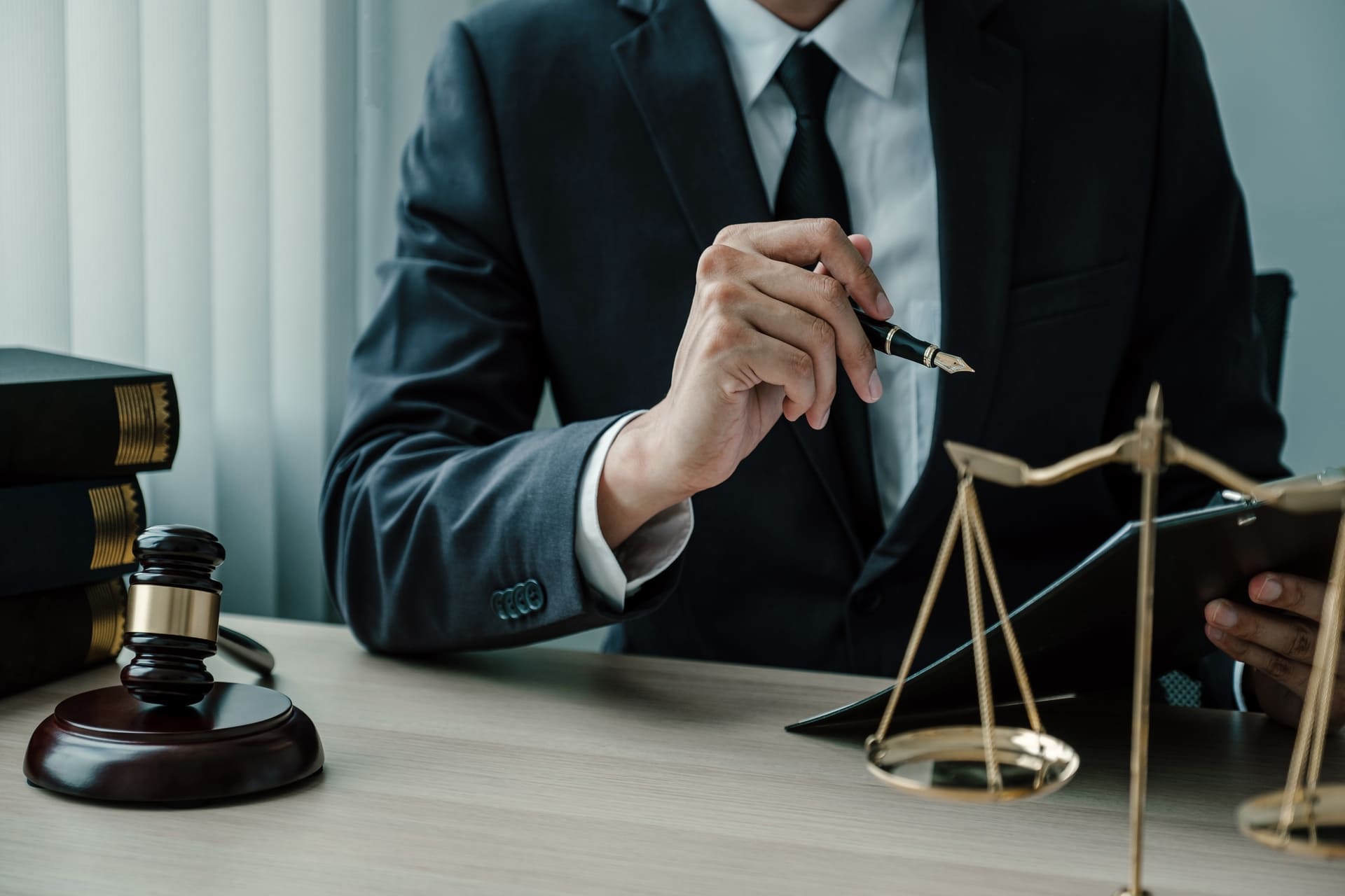 lawyer sitting in front of scales of justice