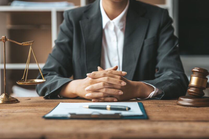 Woman Lawyer sits, looking at tax case