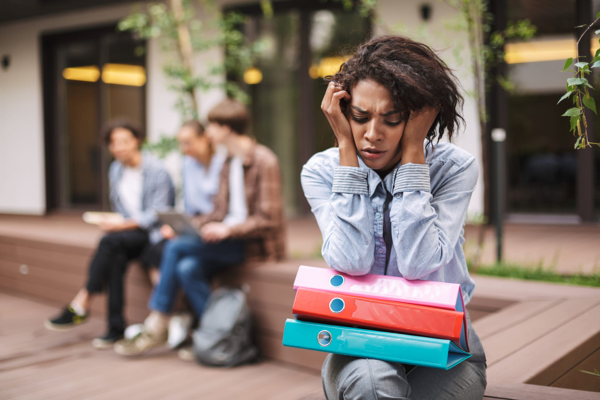 Lady sitting outside troubled by student debt