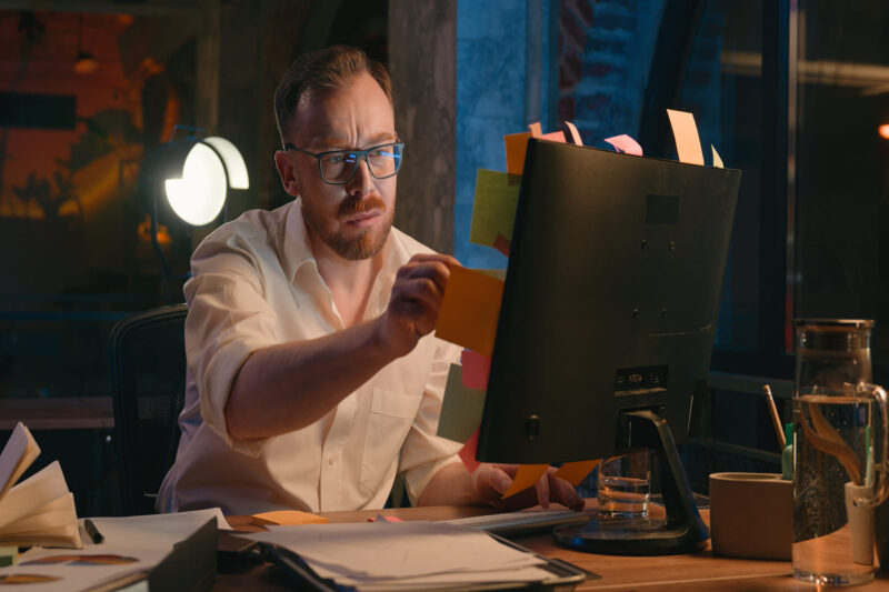 Debt collector looking at computer screen