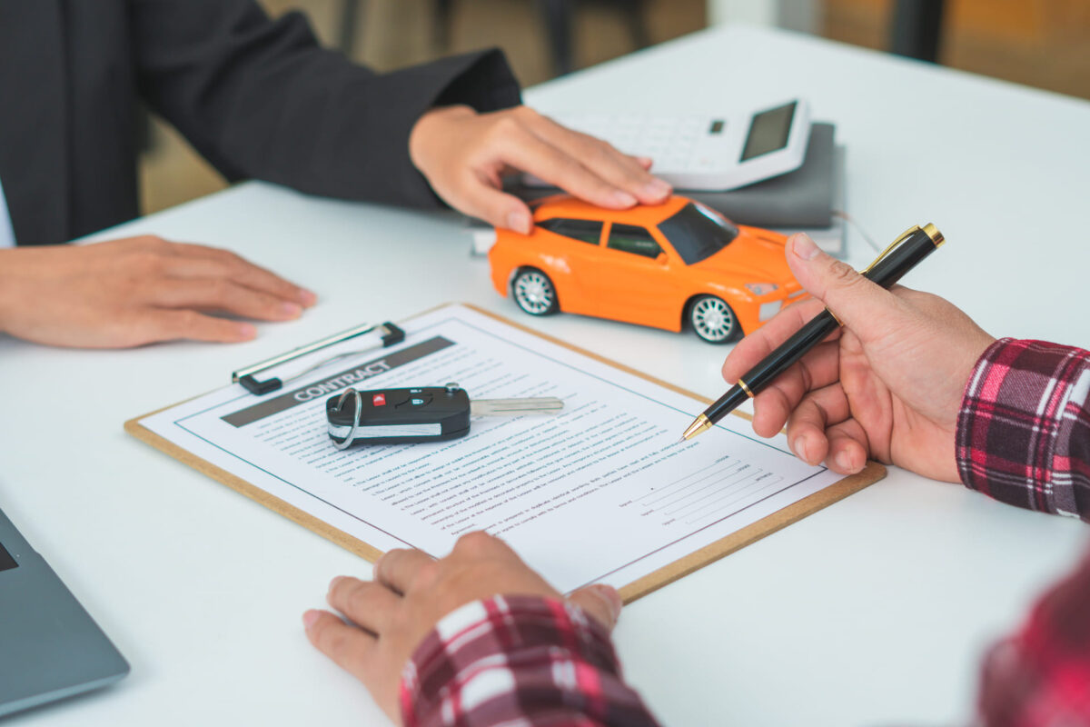 Picture of man signing car loan