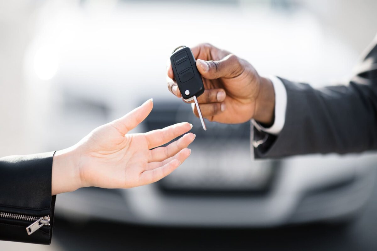 car dealer giving keys to buyer