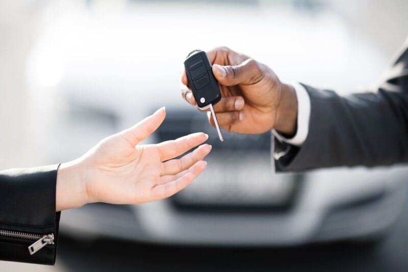 car dealer giving keys to buyer