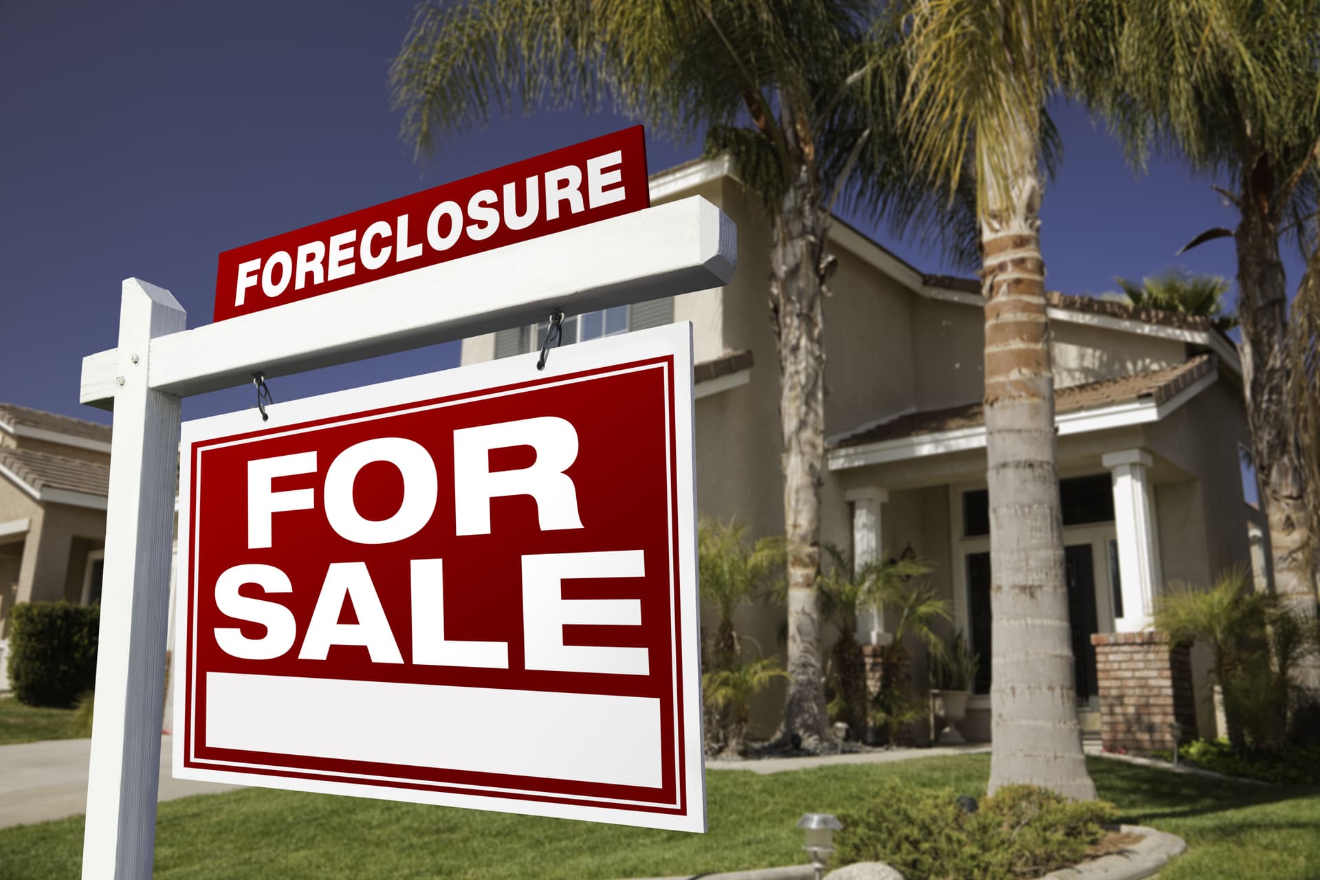 foreclosure for sale sign in front of house
