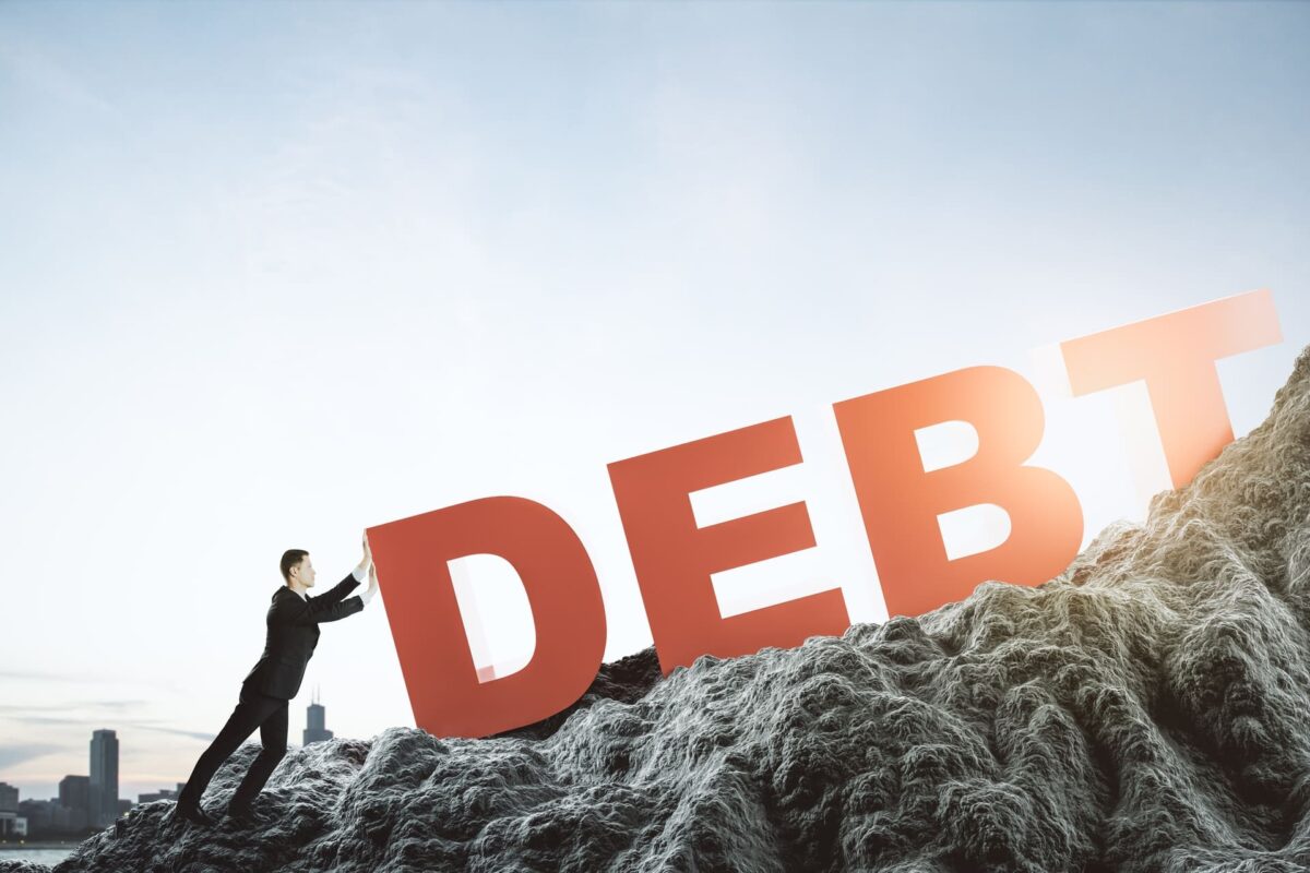Illustration of a man pushing "debt" uphill