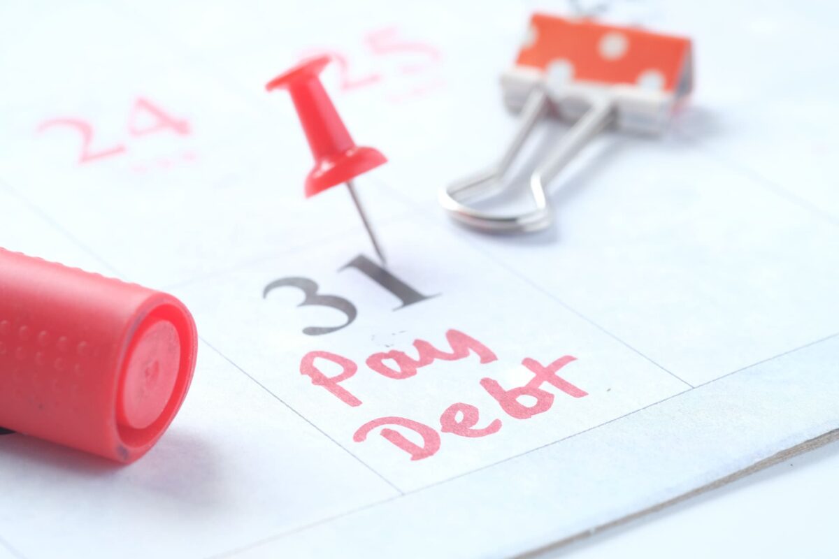 close up of pay debt word on calendar