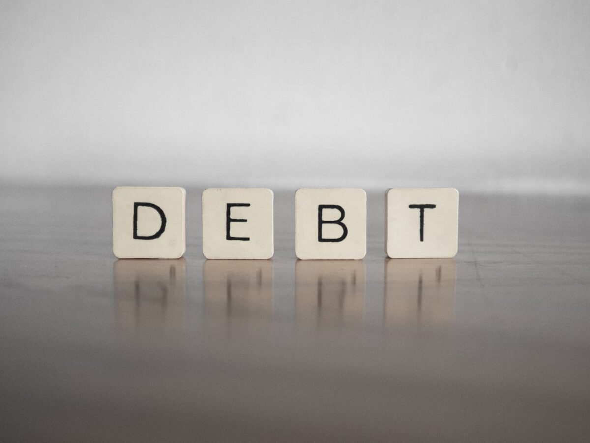 close up of building blocks writing out debt