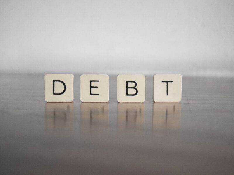 close up of building blocks writing out debt