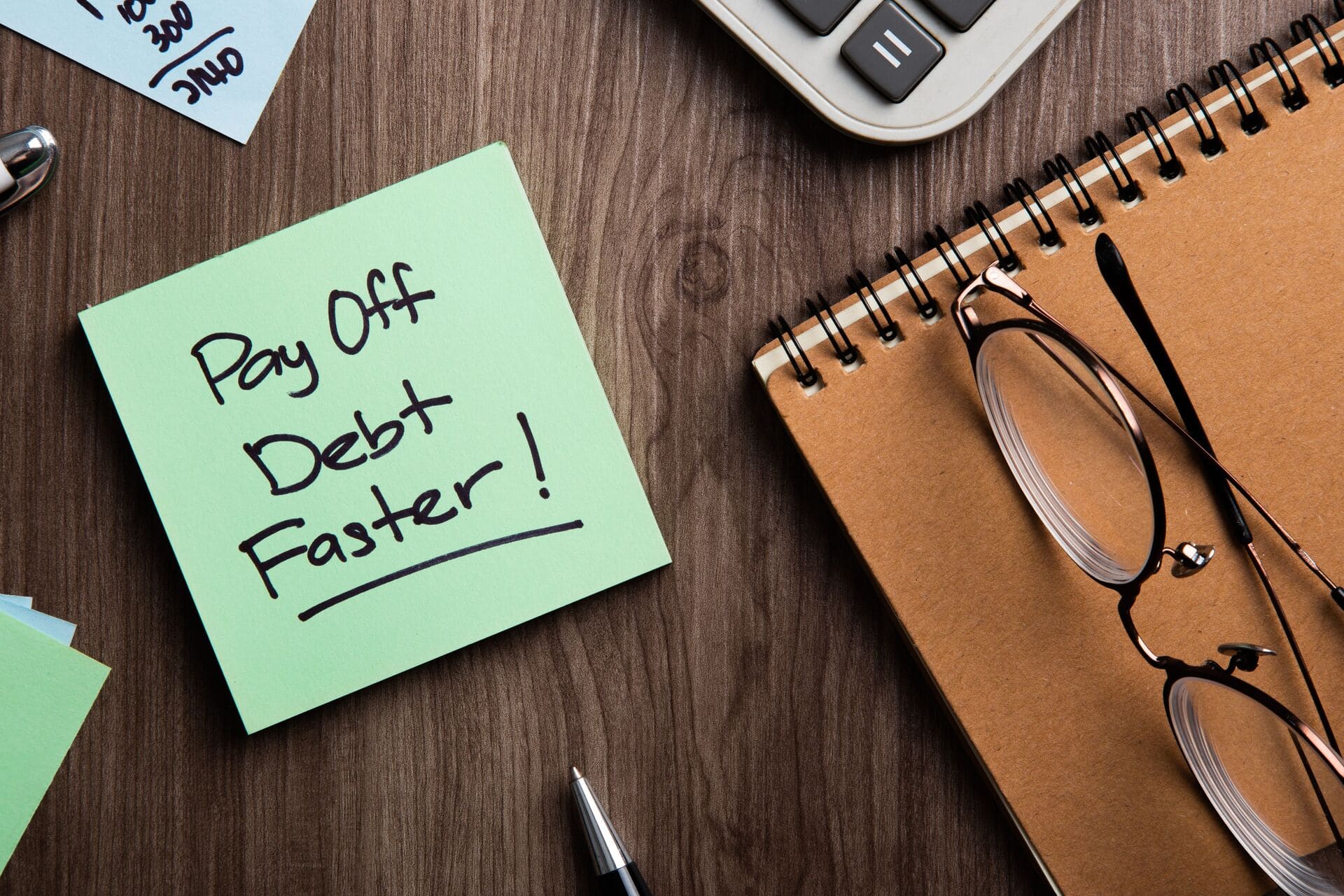 sticky note reading out: pay off debt faster