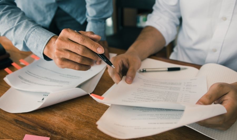 man checking the repossession documents with the management