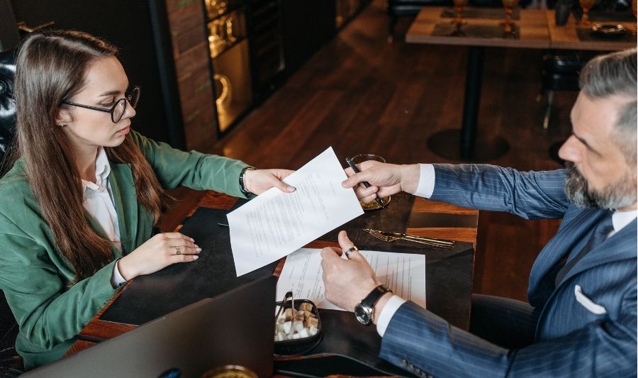 woman giving important documents to a man