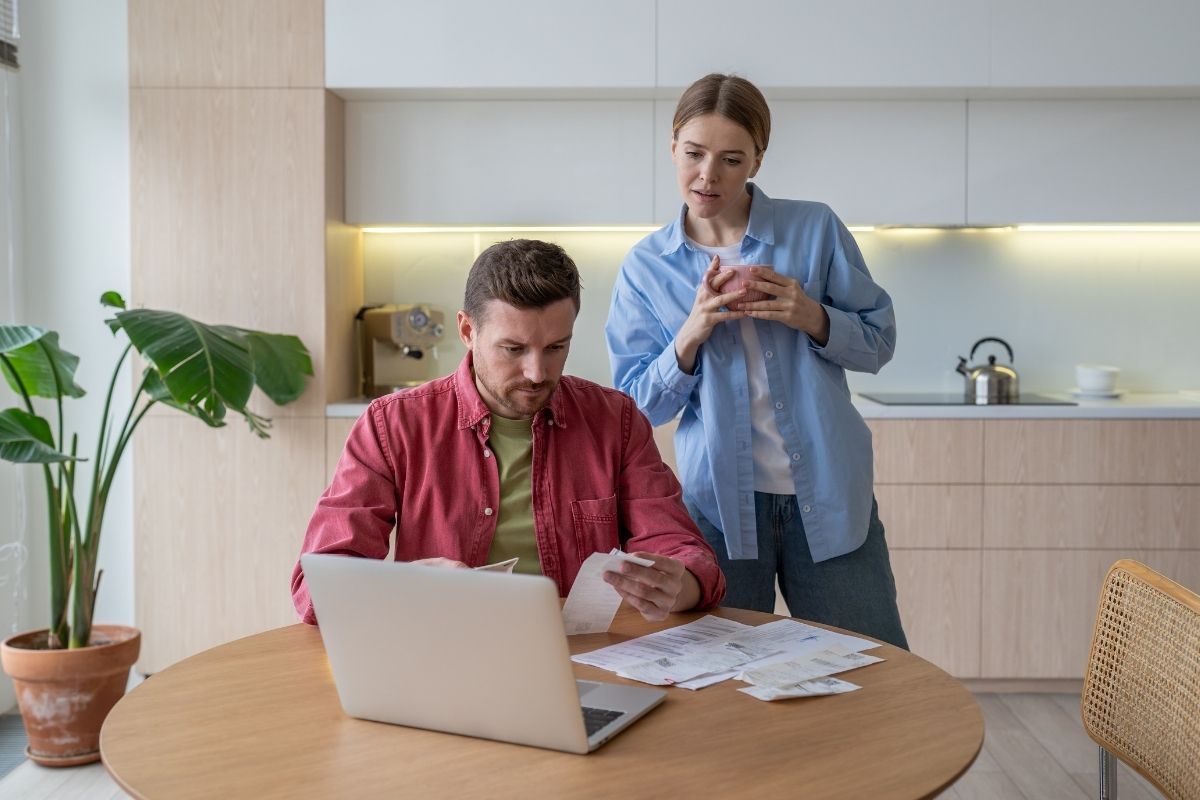 couple looking for pile of bills and receipts