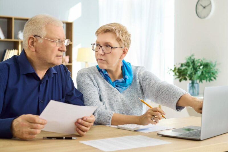 senior couple reviewing bank statement