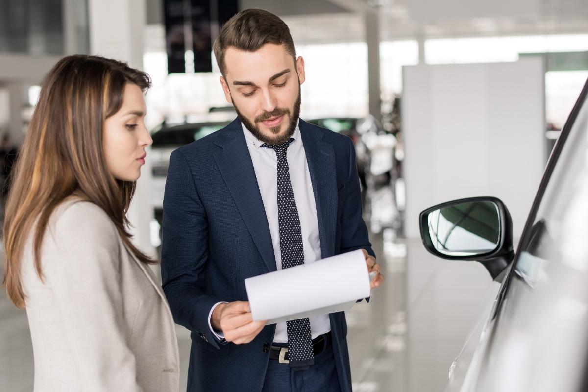 woman asking the dealership for options